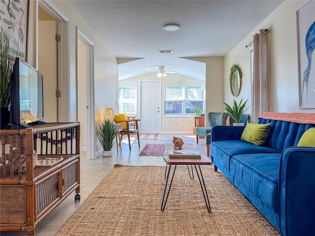 living room with light tile patterned floors, vaulted ceiling, and ceiling fan