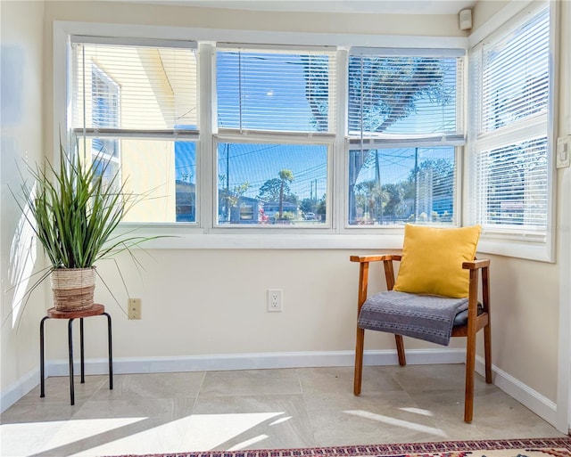 living area with light tile patterned flooring and a wealth of natural light