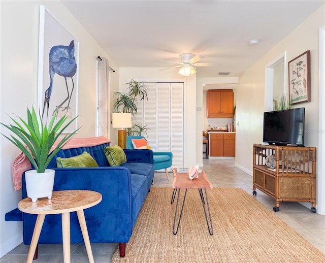 tiled living room featuring ceiling fan