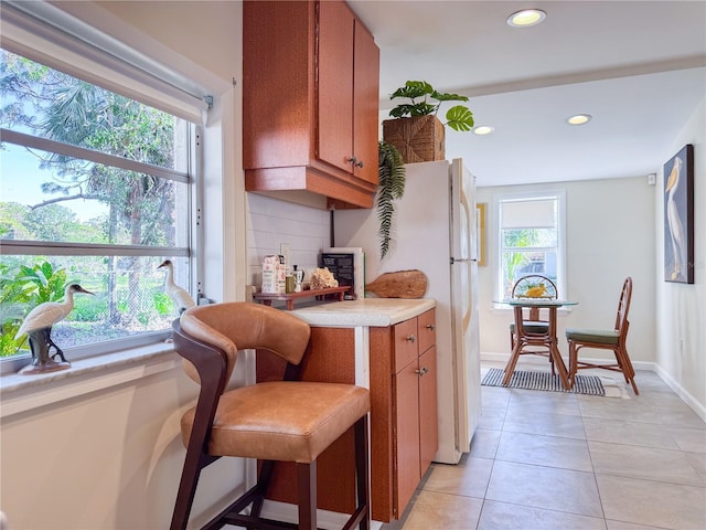 kitchen featuring decorative backsplash and light tile patterned floors