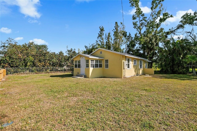 view of side of home featuring a lawn