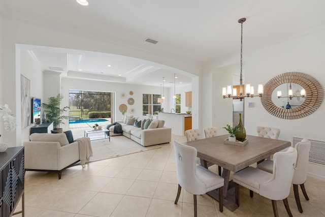 dining room with light tile patterned floors, ornamental molding, visible vents, and a notable chandelier