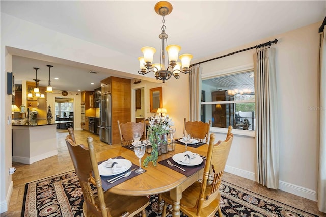 dining space with sink and a notable chandelier