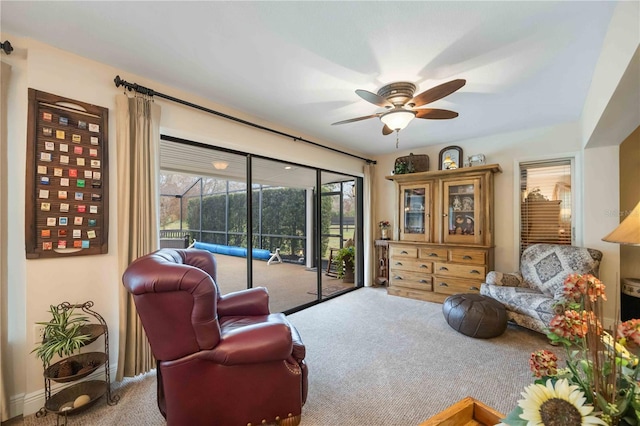 sitting room featuring ceiling fan and carpet floors