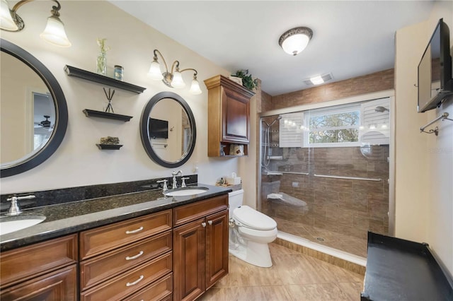 bathroom featuring an enclosed shower, vanity, and toilet