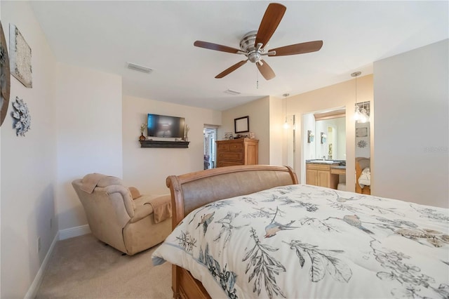 carpeted bedroom with ceiling fan and ensuite bathroom