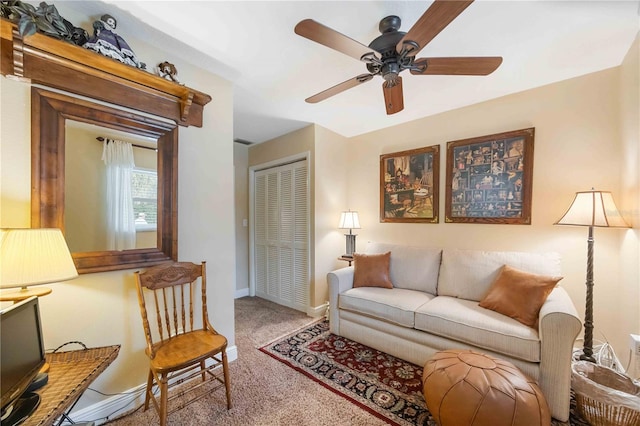 carpeted living room with ceiling fan