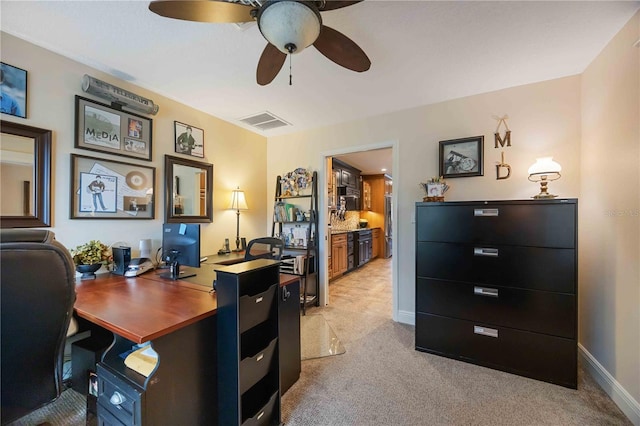 carpeted office with ceiling fan