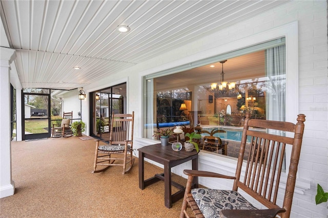 sunroom featuring an inviting chandelier