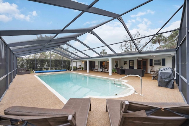 view of swimming pool with an outdoor living space, a lanai, and a patio area