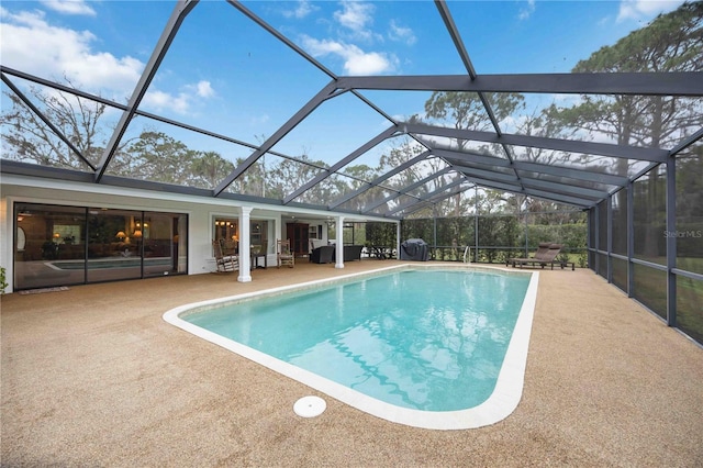 view of pool featuring a patio area and glass enclosure