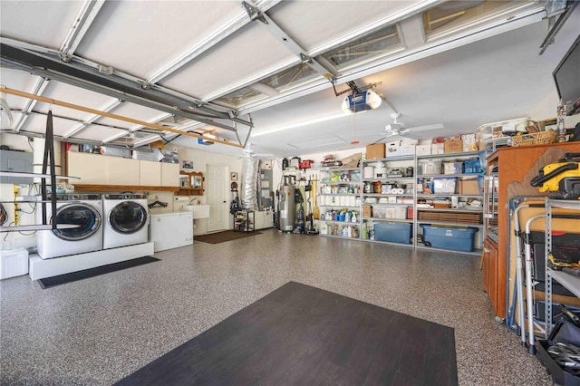 garage with water heater, sink, washing machine and clothes dryer, ceiling fan, and a garage door opener