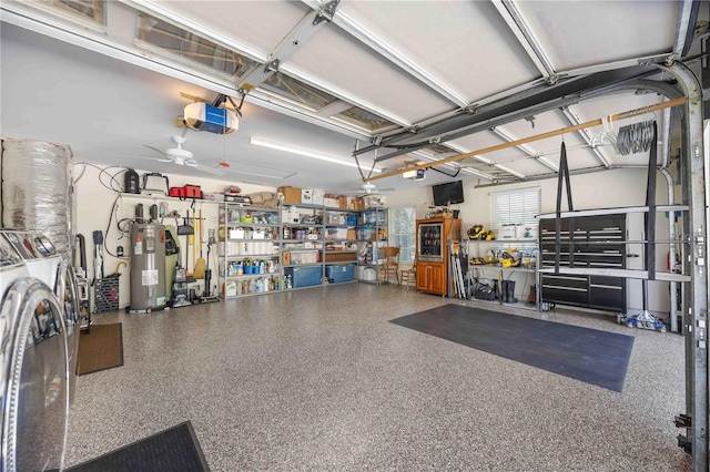 garage with a garage door opener, a workshop area, electric water heater, and washing machine and clothes dryer