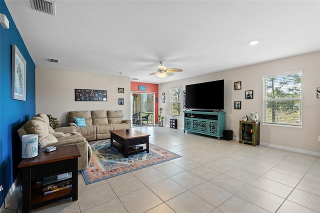 tiled living room with ceiling fan