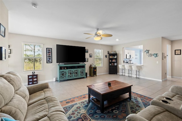 tiled living room with ceiling fan and a healthy amount of sunlight