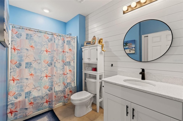 full bathroom with wooden walls, tile patterned flooring, vanity, toilet, and shower / bath combo