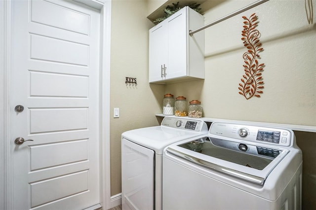 laundry room featuring cabinet space and washing machine and clothes dryer