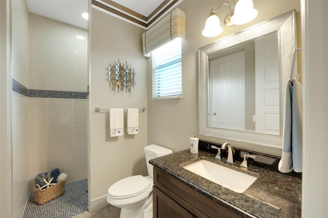 bathroom featuring toilet, vanity, and crown molding