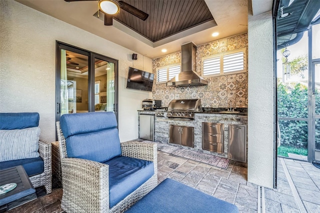 view of patio / terrace featuring a sink, exterior kitchen, and a grill