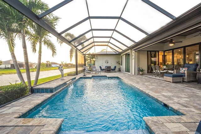 outdoor pool with a ceiling fan, a lanai, a patio, and an outdoor hangout area