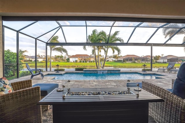 pool with glass enclosure, a hot tub, a residential view, and a patio