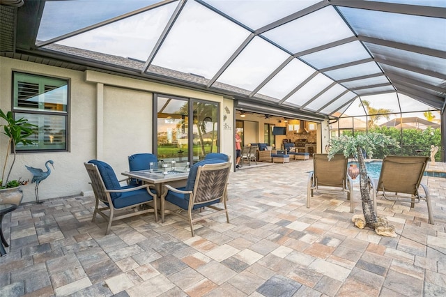 view of patio with glass enclosure, outdoor dining area, an outdoor pool, and an outdoor living space