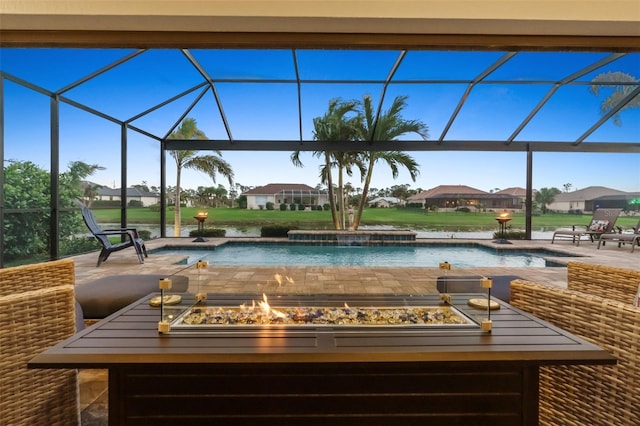 pool with a residential view, glass enclosure, a patio, and a fire pit