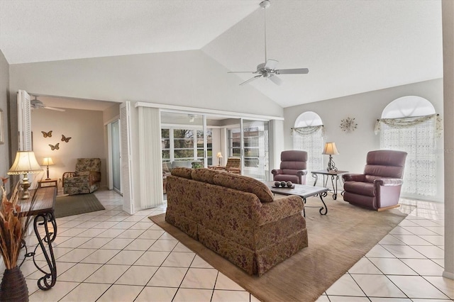 living room with light tile patterned flooring, ceiling fan, and vaulted ceiling