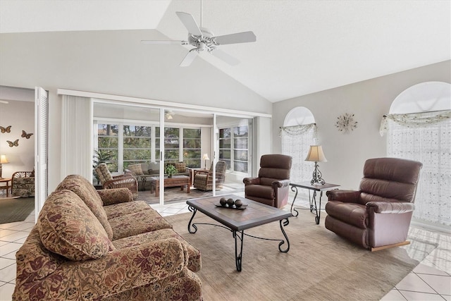 living room featuring ceiling fan, high vaulted ceiling, and light tile patterned floors