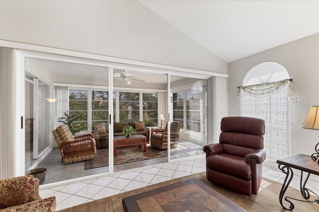 sitting room featuring light tile patterned flooring, ceiling fan, and high vaulted ceiling