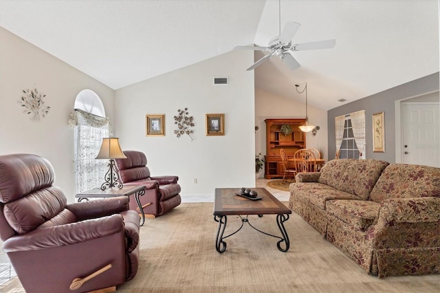 living room with ceiling fan and vaulted ceiling