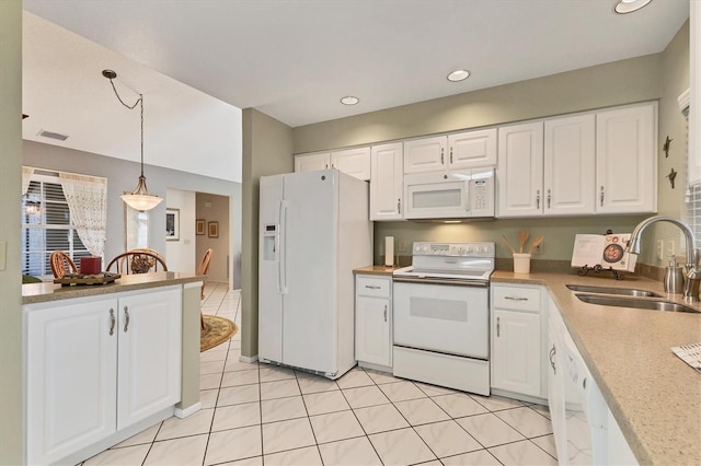 kitchen with sink, white cabinetry, hanging light fixtures, light tile patterned floors, and white appliances