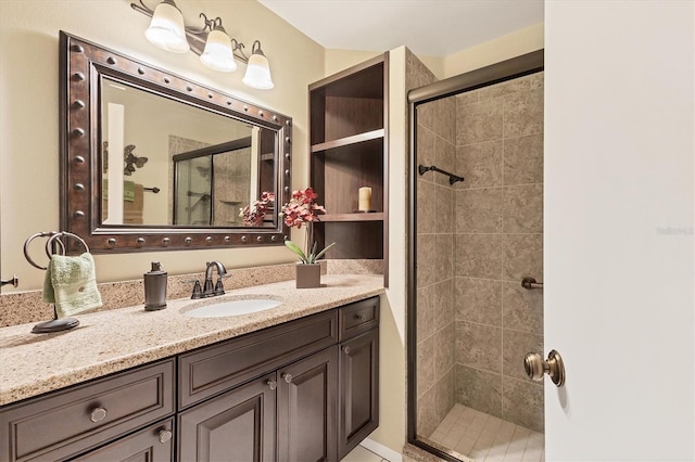 bathroom featuring vanity and a shower with shower door