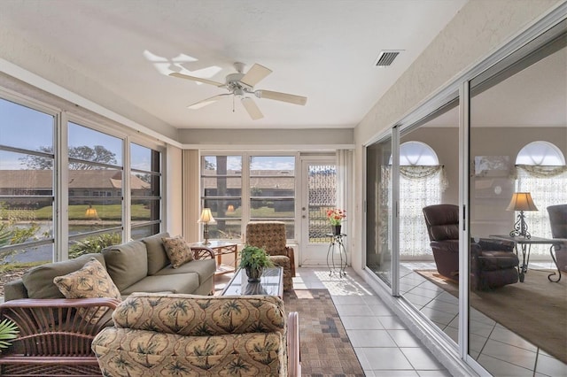 sunroom / solarium featuring ceiling fan