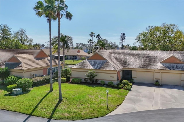 ranch-style house with a garage and a front lawn