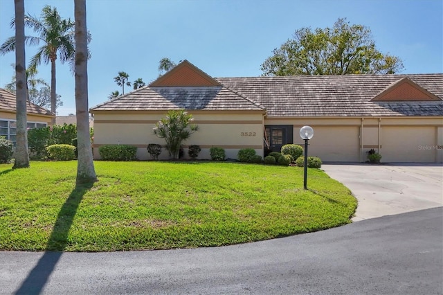 single story home with a garage and a front yard