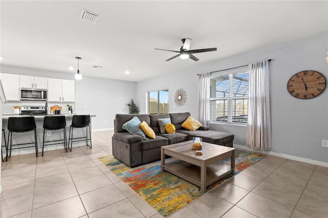 living room featuring light tile patterned flooring and ceiling fan