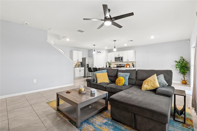 tiled living room featuring sink and ceiling fan