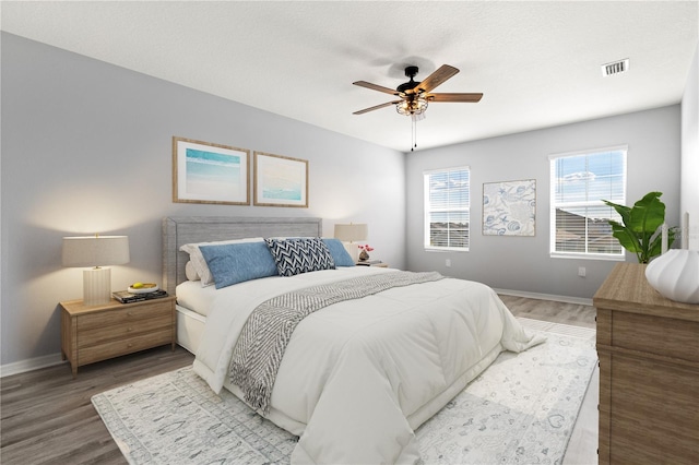 bedroom featuring wood-type flooring and ceiling fan