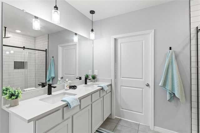 bathroom with vanity, a shower with door, and tile patterned flooring