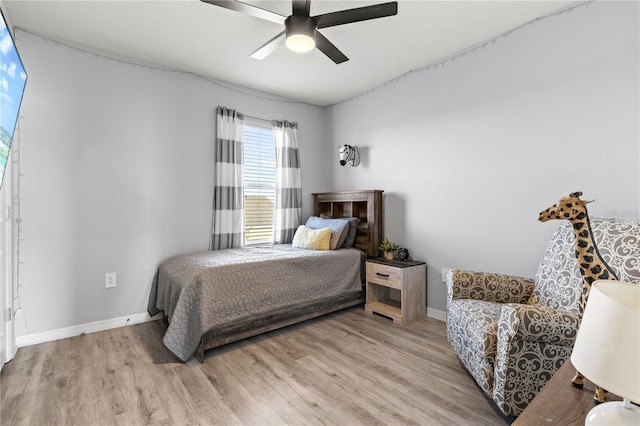 bedroom with ceiling fan and light hardwood / wood-style flooring