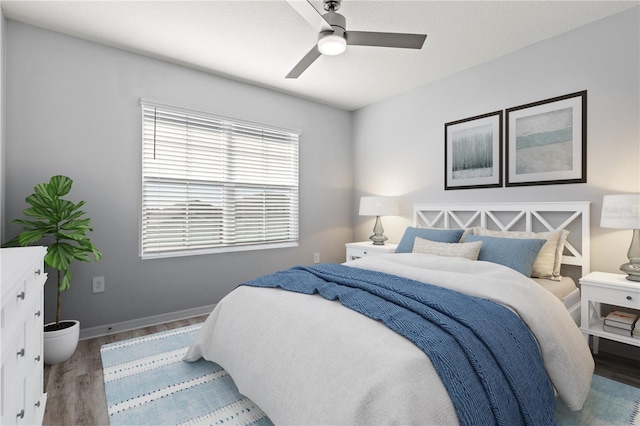 bedroom with wood-type flooring and ceiling fan