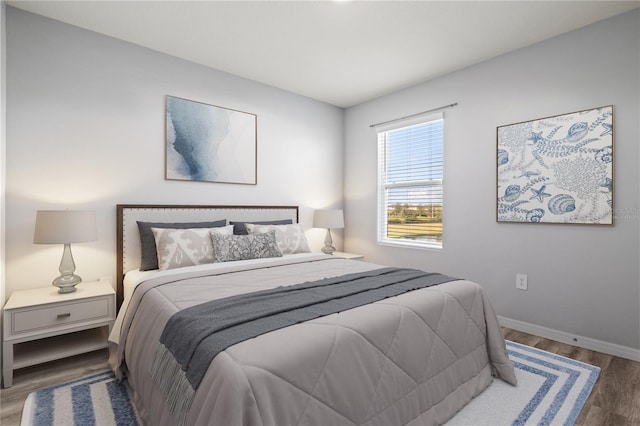 bedroom with dark wood-type flooring