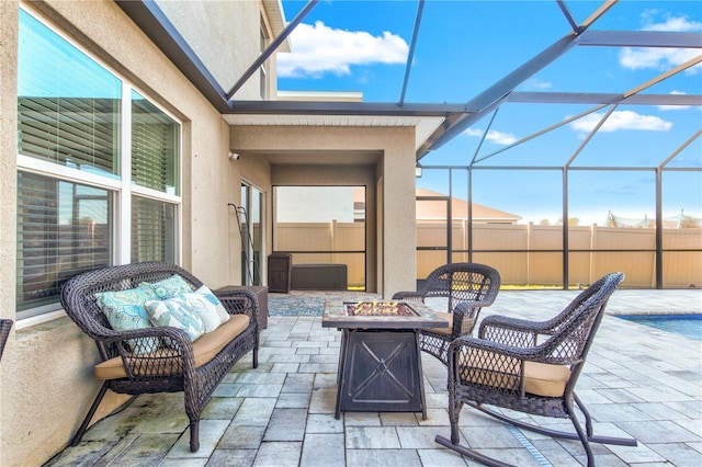 view of patio with a lanai and a fire pit