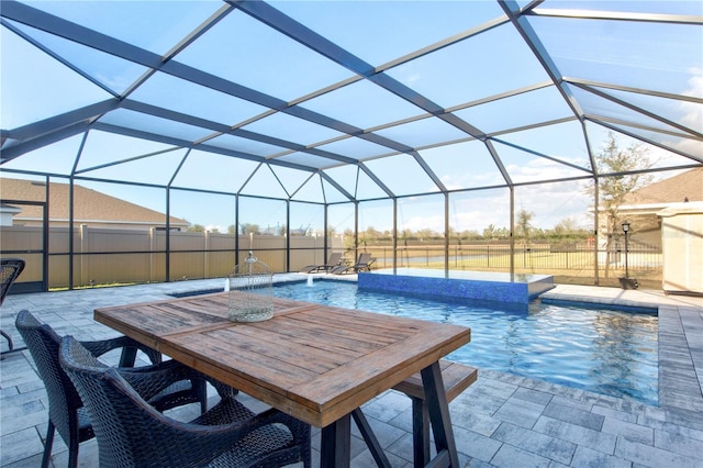 view of swimming pool featuring pool water feature, a lanai, and a patio area