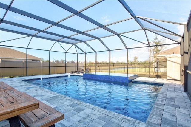 view of pool featuring a patio, pool water feature, and glass enclosure