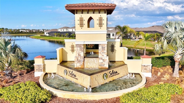 community / neighborhood sign featuring a water view