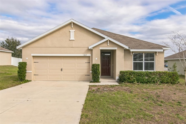 view of front of property with roof with shingles, stucco siding, concrete driveway, an attached garage, and a front lawn