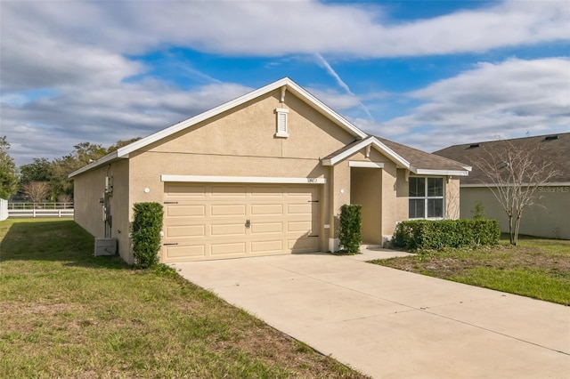 ranch-style home featuring a garage, driveway, stucco siding, fence, and a front yard