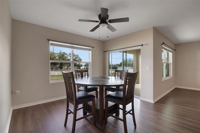 dining area with a textured ceiling, baseboards, dark wood finished floors, and a ceiling fan